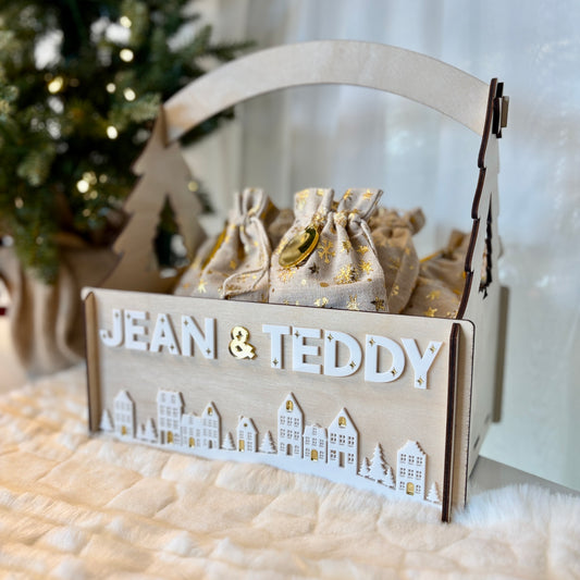 Wooden gift basket with 'JEAN & TEDDY' branding, filled with small bags, against a soft white background.