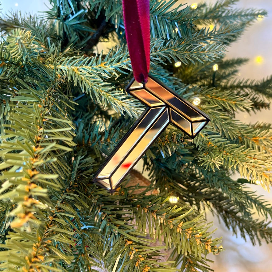 Gold mirrored initial T Christmas decoration hanging on tree
