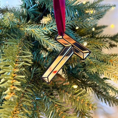 Gold mirrored initial T Christmas decoration hanging on tree
