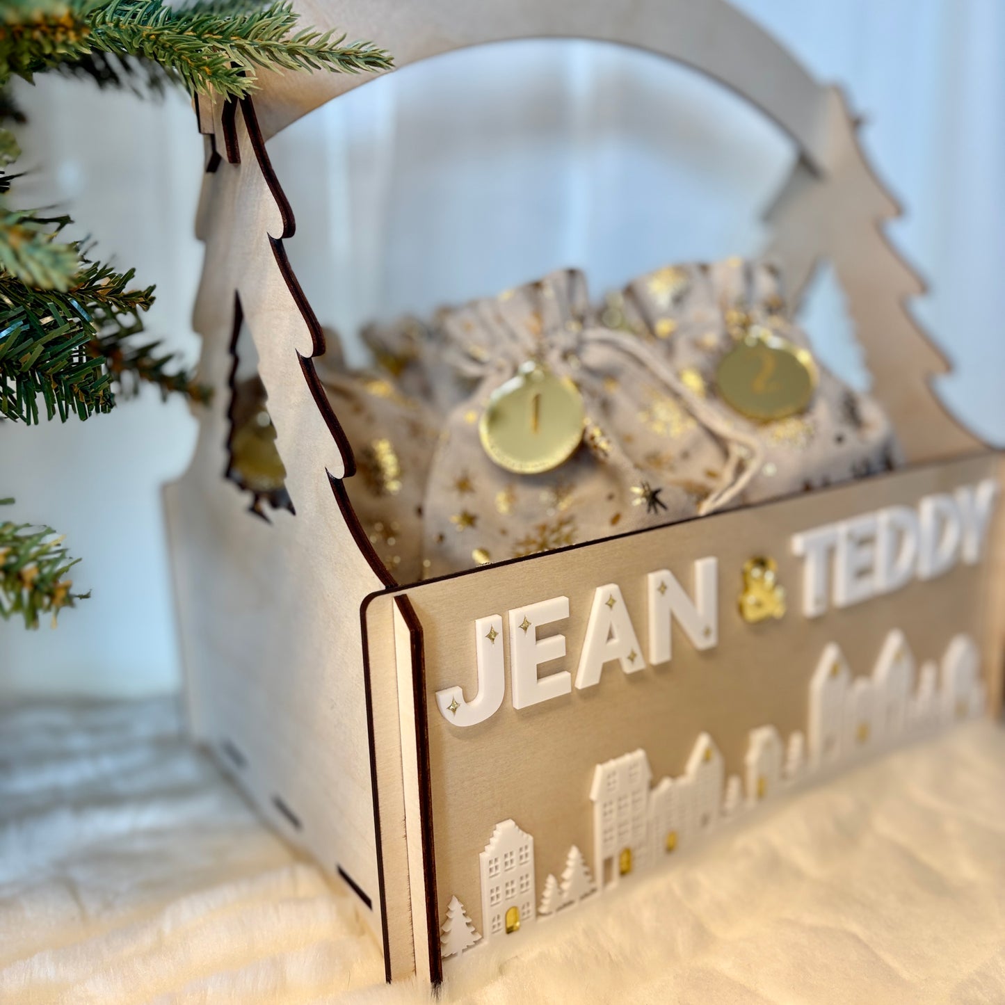 Decorative gift box with 'JEAN & TEDDY' text, Christmas tree in the background