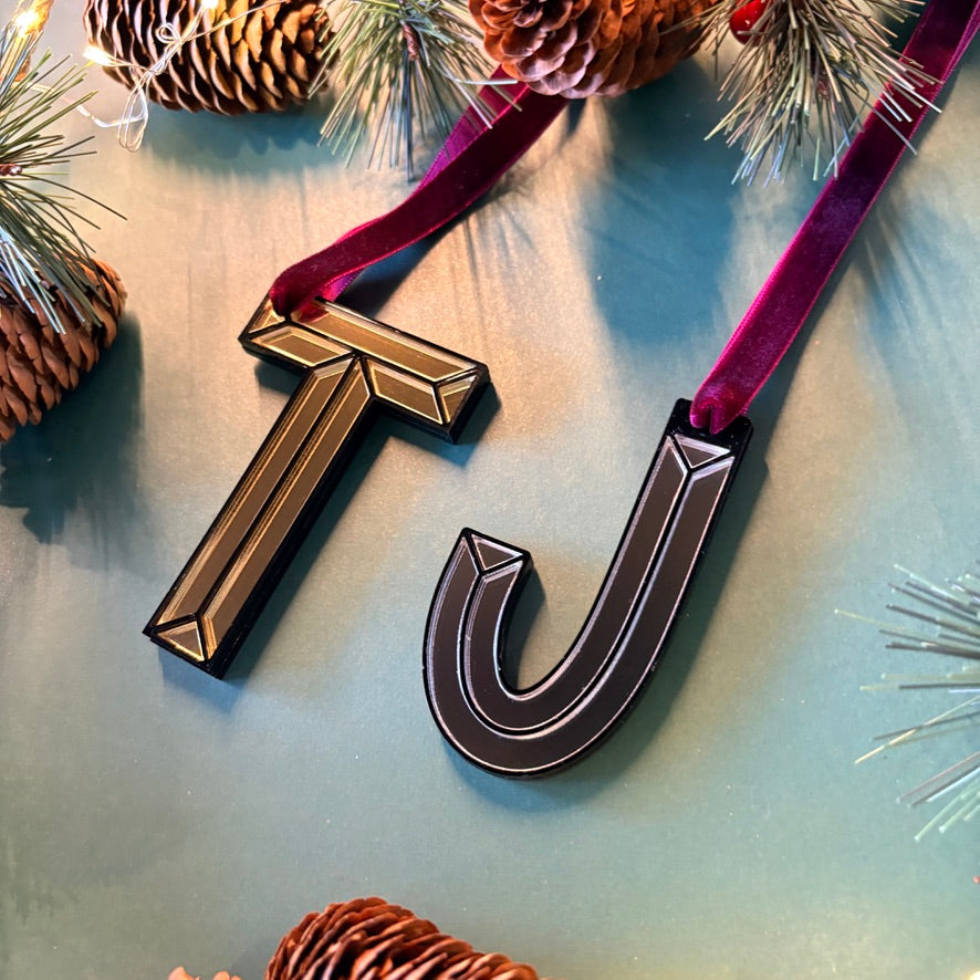 Gold mirrored initial T Christmas decoration hanging on tree
Silver acrylic initial J Christmas ornament with velvet ribbon