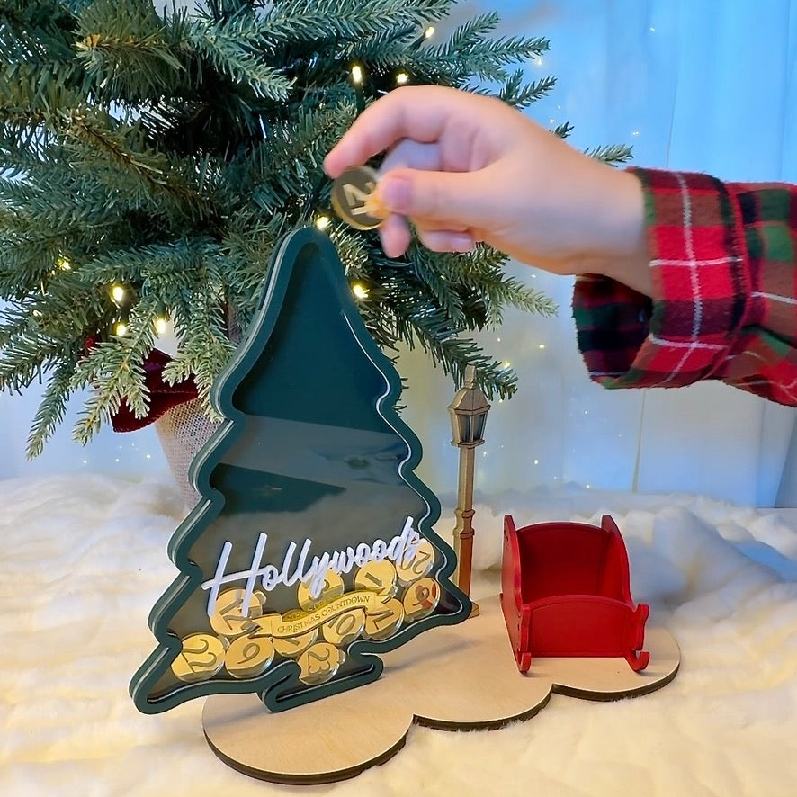 Decorative Christmas tree ornament with gold coins, red sleigh and gold lamp post