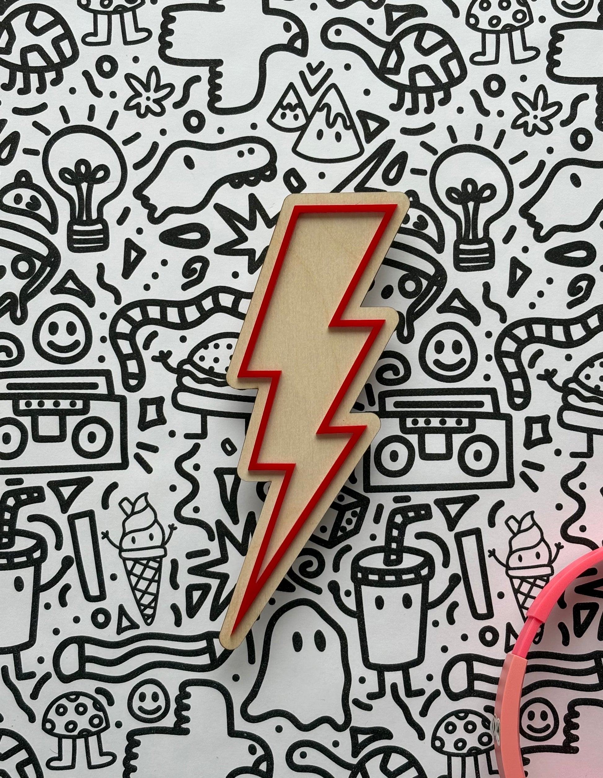Wooden lightning bolt-shaped object on a patterned background