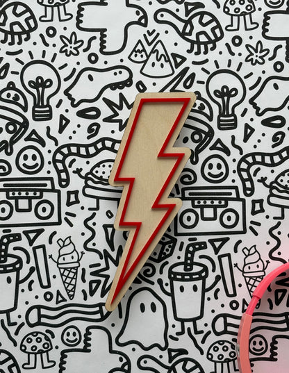 Wooden lightning bolt-shaped object on a patterned background